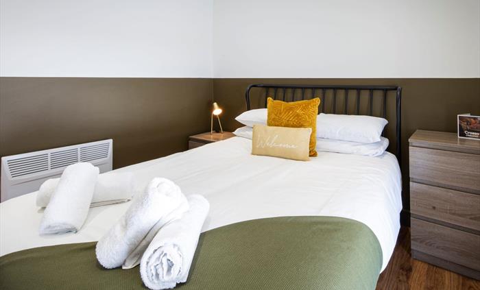 Double bed with towels and pillows